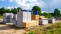 Construction site with building materials, concrete blocks, and lumber outdoors on a sunny day. Royalty Free Stock Photo