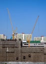 Construction site building with yellow crane and scaffolding Royalty Free Stock Photo