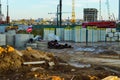 Construction site in the city center. tumbled down the stop sign. building materials are piled in a pile under the film. a house