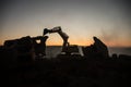 Construction site on a city street. A yellow digger excavator parked during the night on a construction site. Industrial concept t Royalty Free Stock Photo