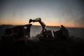 Construction site on a city street. A yellow digger excavator parked during the night on a construction site. Industrial concept t Royalty Free Stock Photo