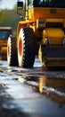 Construction site close-up: Yellow roller compacts black asphalt, transforming country road. Royalty Free Stock Photo