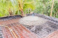 Construction site: Concrete from bucket loaded to roof slab formwork and reinforcement bar