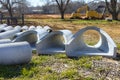 At construction site, concrete drainage sewage stormwater pipes are stacked for installation