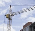 Construction site. Construction cranes and high-rise building under construction against blue sky. Royalty Free Stock Photo