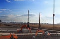 Construction site with construction machines an excavator and piling machine that level the ground and drive piles