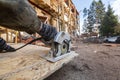 Construction Site. Construction worker with electrical circular saw saws the cement particle board oudoor near house