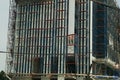 Construction site, Construction workers assembling scaffolding of tall buildings. Safety first, seat belts, Royalty Free Stock Photo