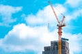 Construction site with crane and building. Real estate industry. Crane use reel lift up equipment in construction site. Building Royalty Free Stock Photo