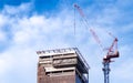 Construction site with crane and building. Real estate industry. Crane use reel lift up equipment in construction site. Building Royalty Free Stock Photo