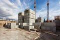 construction site with crane lifting heavy concrete blocks, for building projects