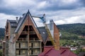 Construction site with crane and unfinished cottage in Ukrainian Carpathian village Royalty Free Stock Photo