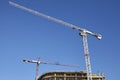 Construction site cranes against the blue sky Royalty Free Stock Photo