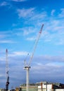 Construction site with cranes against blue sky Royalty Free Stock Photo
