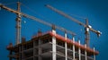 Construction Site with Cranes Against Blue Sky Progress Development and Infrastructure Project for Residential Building Industry Royalty Free Stock Photo