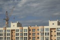 Construction site with cranes and building with cloudy sky background Royalty Free Stock Photo