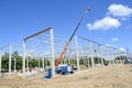 Construction site with cranes building a warehouse