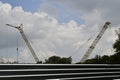 Construction site with cranes and cloudy sky on the background Royalty Free Stock Photo