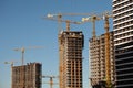 Construction site. Cranes and concrete buildings. Investing in new real estate Royalty Free Stock Photo