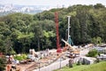 Construction site with cranes and natural background.