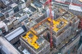 Construction site with cranes among other urban other houses. Construction workers are building. Aerial view. Top view Royalty Free Stock Photo