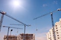 Construction site with cranes on sky background. Sunny day Royalty Free Stock Photo