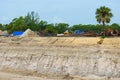 Construction site with deep hole excavation and work trucks Royalty Free Stock Photo