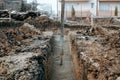 Construction site details - concrete pump, automatic pipe pump working and pouring fresh cement Royalty Free Stock Photo