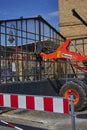 Construction site on the Dresden railway line. You see an excavator that supports the workers in dismantling an old, glass bicycle Royalty Free Stock Photo