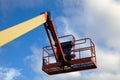 Boom lift construction site elevator equipment lifting platform picker on sky Royalty Free Stock Photo