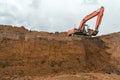 The construction site excavator digs a deep pit. Royalty Free Stock Photo