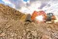 Construction site with an excavator moving rock