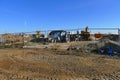 Construction site with excavators for building houses surrounded