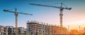 The construction site featuring cranes and ongoing building development against a clear sky. AI generated image Royalty Free Stock Photo