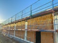 Construction site featuring scaffolding with a clear blue sky in the background, showcasing the Royalty Free Stock Photo