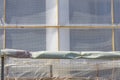 The construction site is fenced with a fence and a protective grid