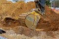 Construction site foundation with excavator working in excavation pit