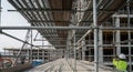 Construction Site Framework with Scaffolding and Workers Under Bright Daylight in a Modern Building Process Royalty Free Stock Photo