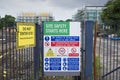 Construction site health and safety message rules sign board signage on fence boundary Royalty Free Stock Photo