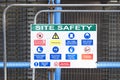 Construction site health and safety message rules sign board signage on fence boundary Royalty Free Stock Photo