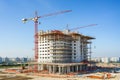 a construction site with a high crane, where a new building is being erected,an overview snapshot