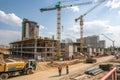 Construction site with hoisting cranes and multi-storey buildings Royalty Free Stock Photo
