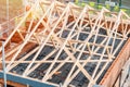 Construction site with house being built from brick and timber, featuring brickwork, roof trusses and scaffolding. House roof Royalty Free Stock Photo
