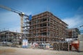 on a construction site a house is completely scaffolded