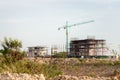 Construction site including several cranes working on a building complex. Construction Site, construction machinery,factory.