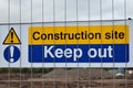 Construction site keep out sign on metal fence with blurred building site in background Royalty Free Stock Photo