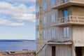 A construction site by the lake and a new house made of concrete and metal. The construction of a skyscraper Royalty Free Stock Photo