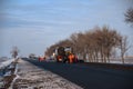 Construction site is laying new asphalt road pavement,road construction workers and road construction machinery scene.