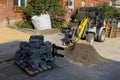 A construction site with a loader moving sand and paving stones. Royalty Free Stock Photo