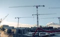 Construction site with lots of cranes and small work houses